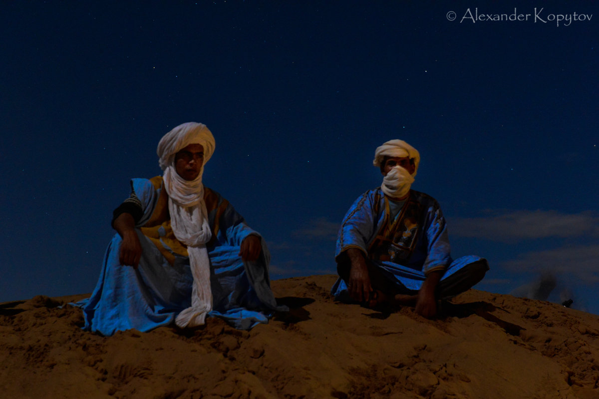 Berber camellers under the full moon in the desert. - Alexander Kopytov