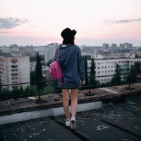 Девушка в шляпе белой рубашке и джинсовой куртке на крыше во время заката с розовым портфелем :: Lenar Abdrakhmanov