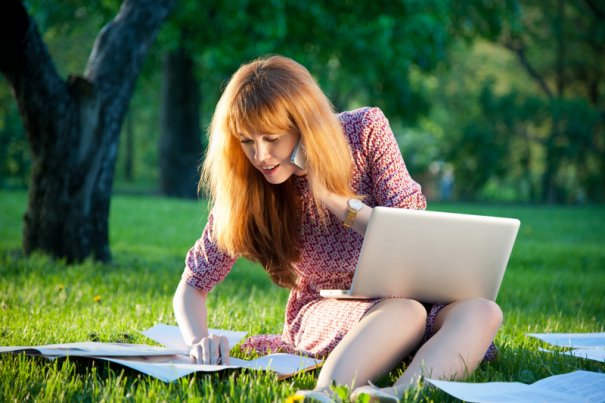 Woman with laptop on the grass